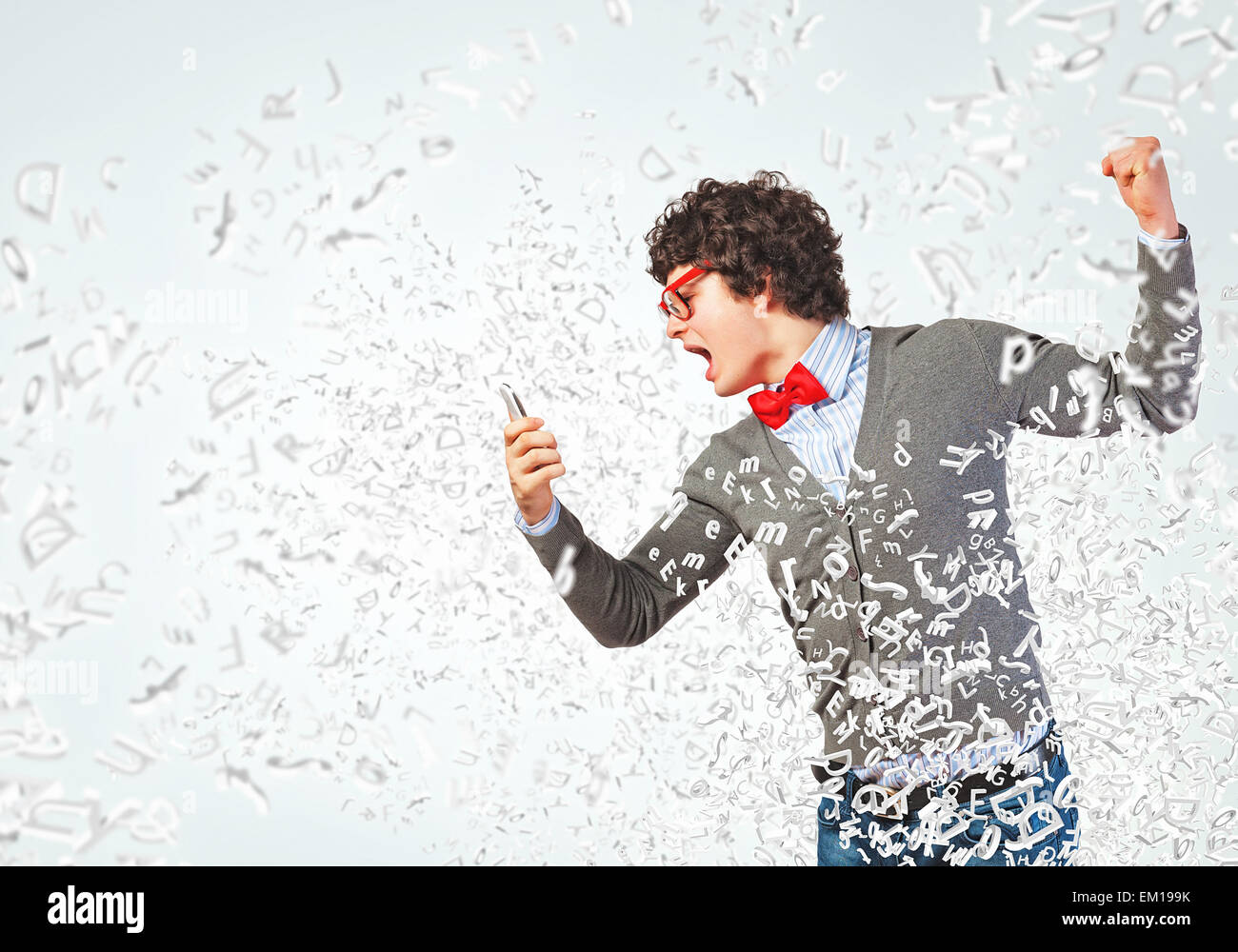 Young man shouting at his mobile phone Stock Photo