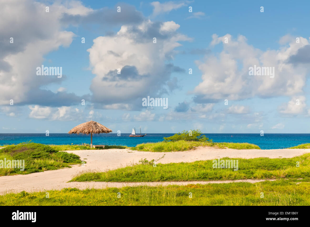 Palapa in deserted beach and turquoise blue caribbean sea - Aruba Stock Photo