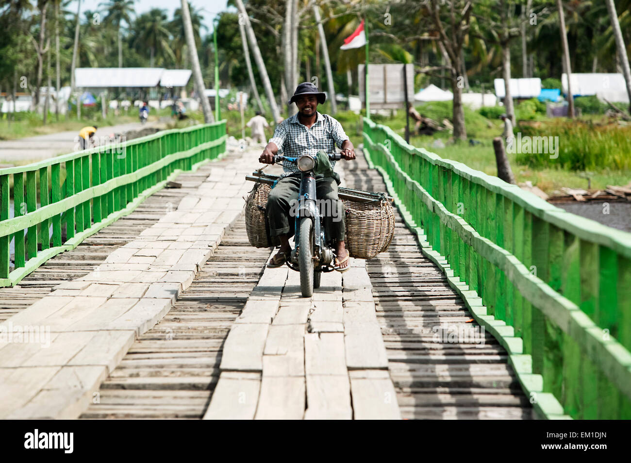 Motorbike crossing a temporary bridge made of wood after the Indian Ocean tsunami in 2004; Sumatra, Indonesia Stock Photo