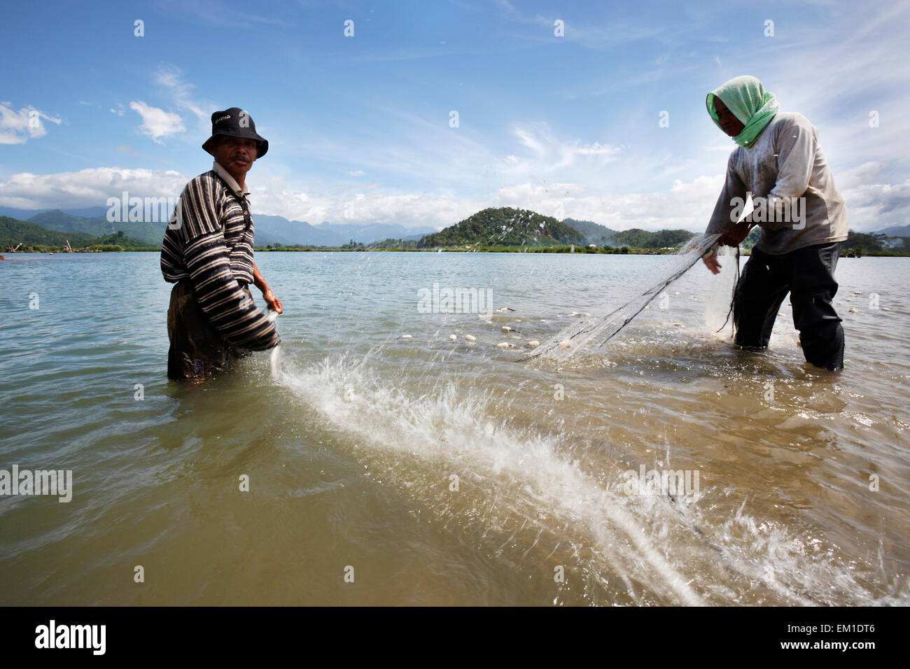 Fishing family bringing in the nets near Lamno; Aceh Province, Sumatra, Indonesia Stock Photo