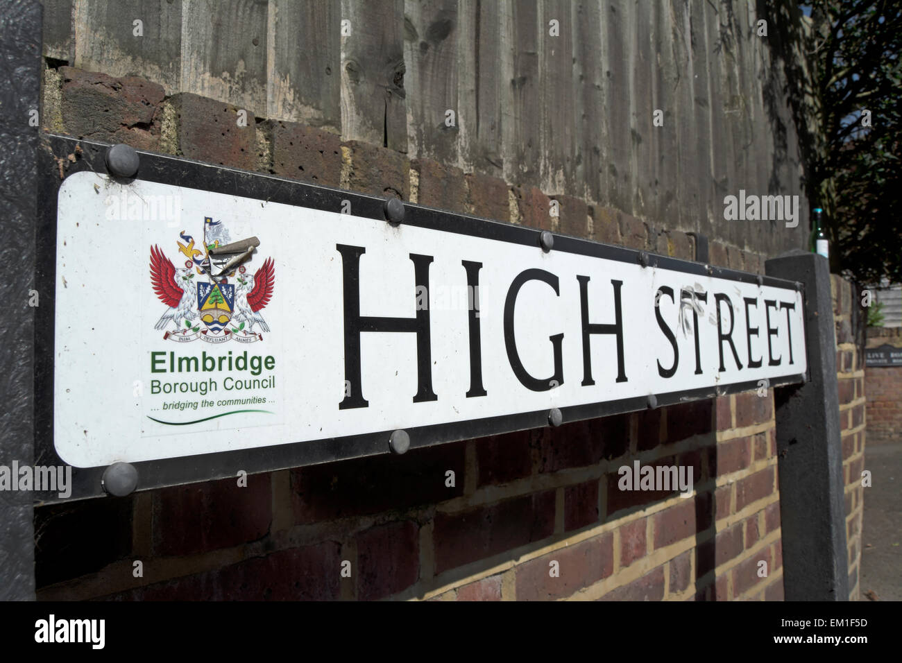 high street street name sign in esher, surrey, england, with crest of elmbridge borough council