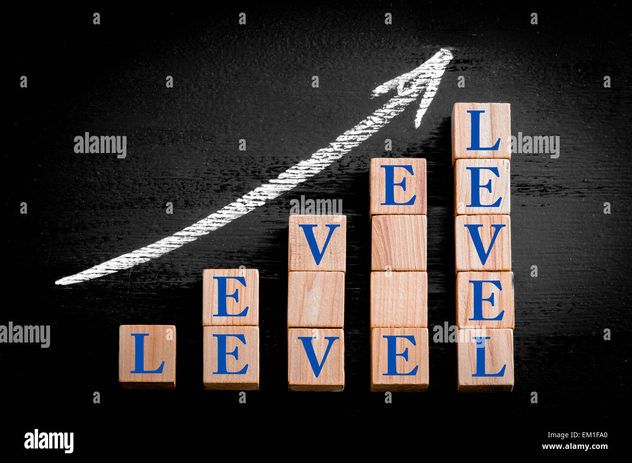 Word LEVEL on ascending arrow above bar graph of Wooden small cubes ...