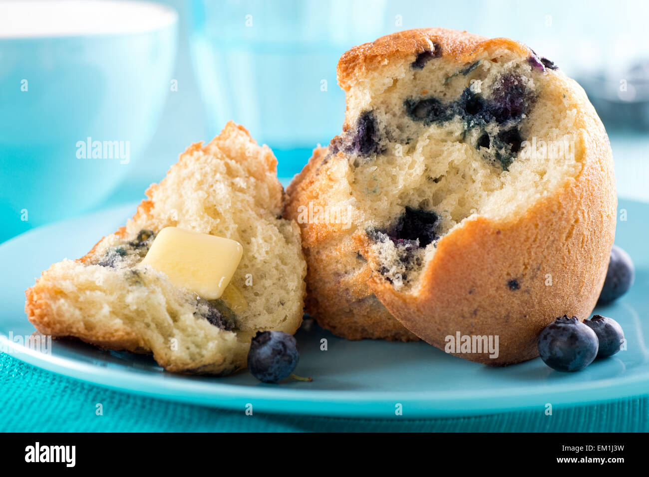 A delicous freshly baked blueberry muffin with melted butter. Stock Photo