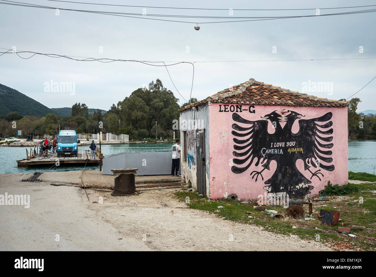 The cable ferry across the Vivari channel at Butrint National Park, with Albanian nationalist Graffiti Southern Albania. Stock Photo