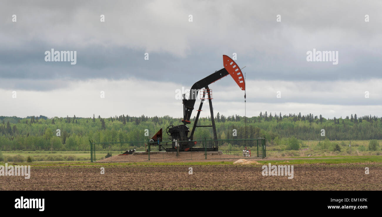 A Pumpjack On An Oil Well; Alberta Canada Stock Photo