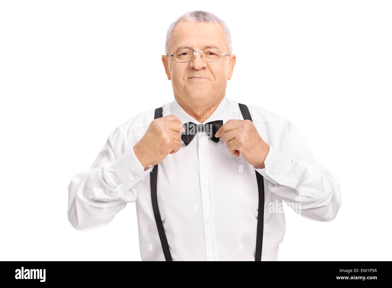 Studio shot of an elegant senior gentleman adjusting his bow-tie isolated on white background Stock Photo