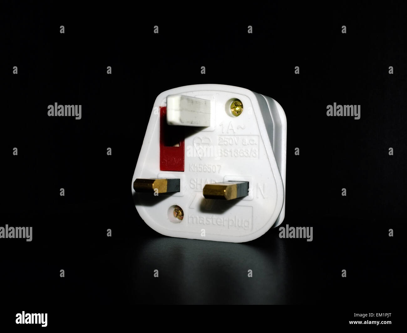 A British three pin plug adapter photographed against a black