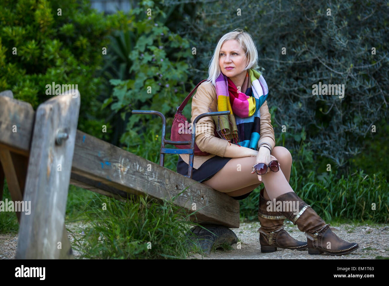 Woman sitting swing hi-res stock photography and images - Alamy