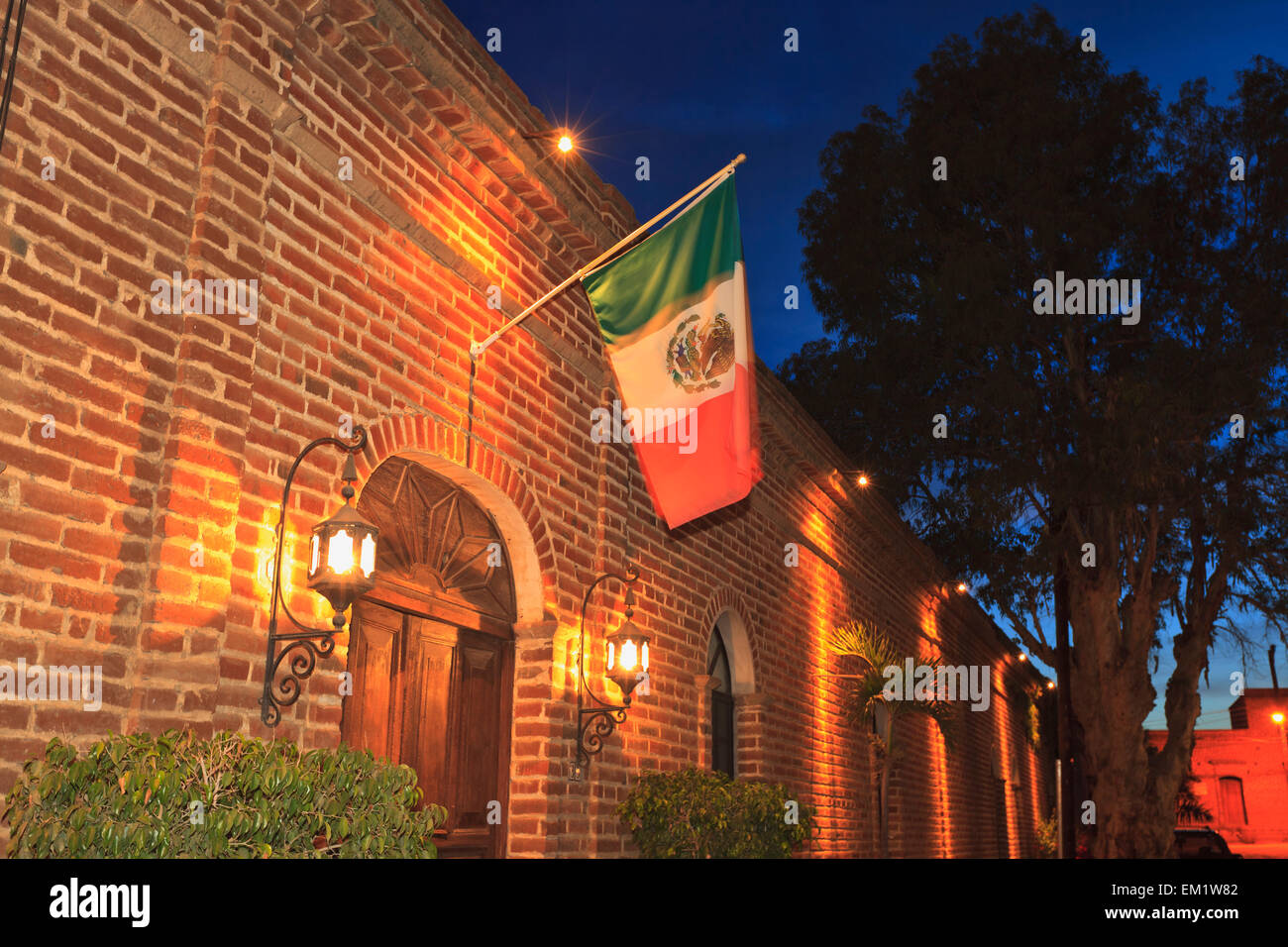 The Mexican Flag Hangs Above The Doorway Of A Building Downtown; Todos Santos Baja California Sur Mexico Stock Photo
