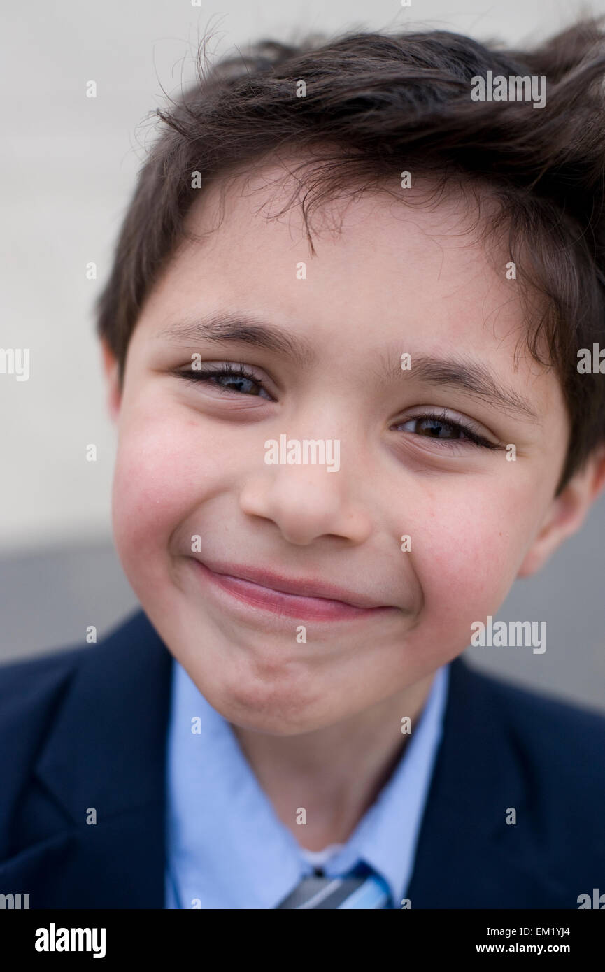 Seven year old boy goofs around in his new suit Stock Photo Alamy