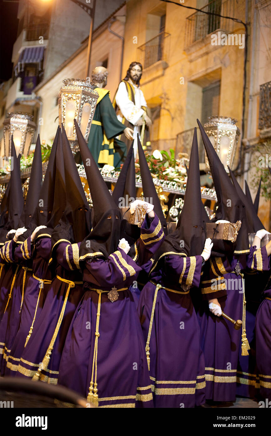Nazarenos carrying a trono (religious float) in a night time procession