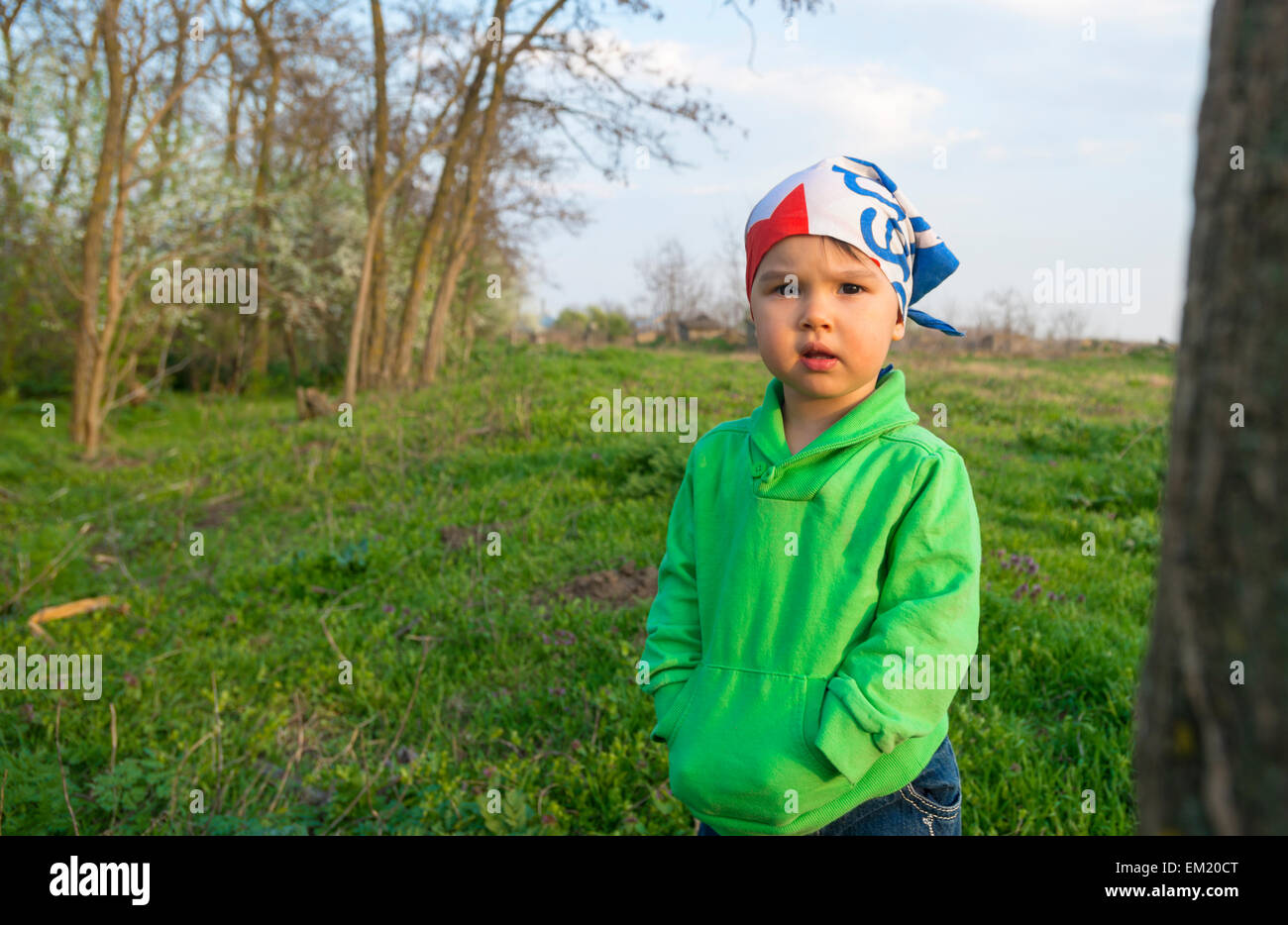 Cute little girl on the meadow in spring day Stock Photo - Alamy