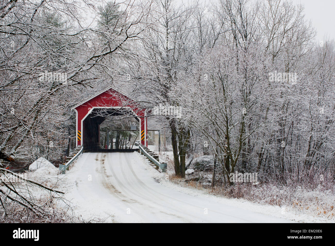 Red Covered Bridge In The Winter; Adamsville Quebec Canada Stock Photo