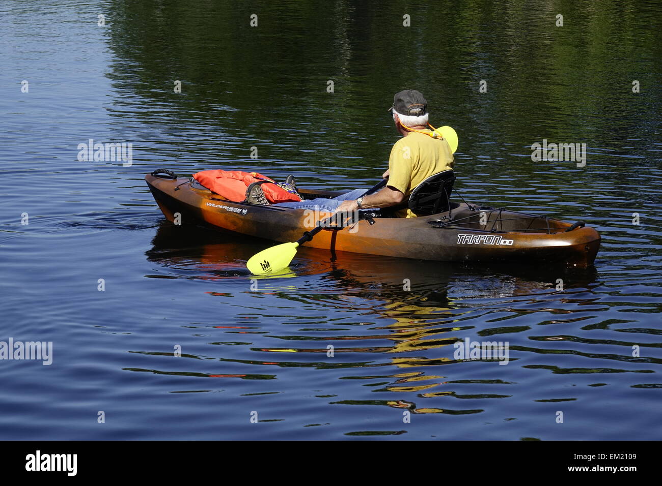 Man paddling Florida river in boat with open cockpit Stock Photo