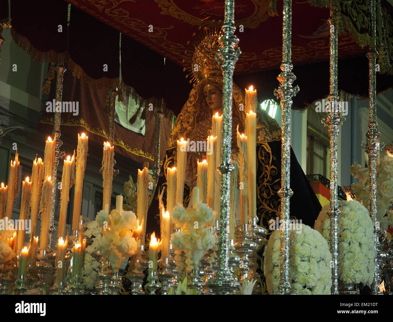 A statue of the Virgin Mary being carried through the streets during a
