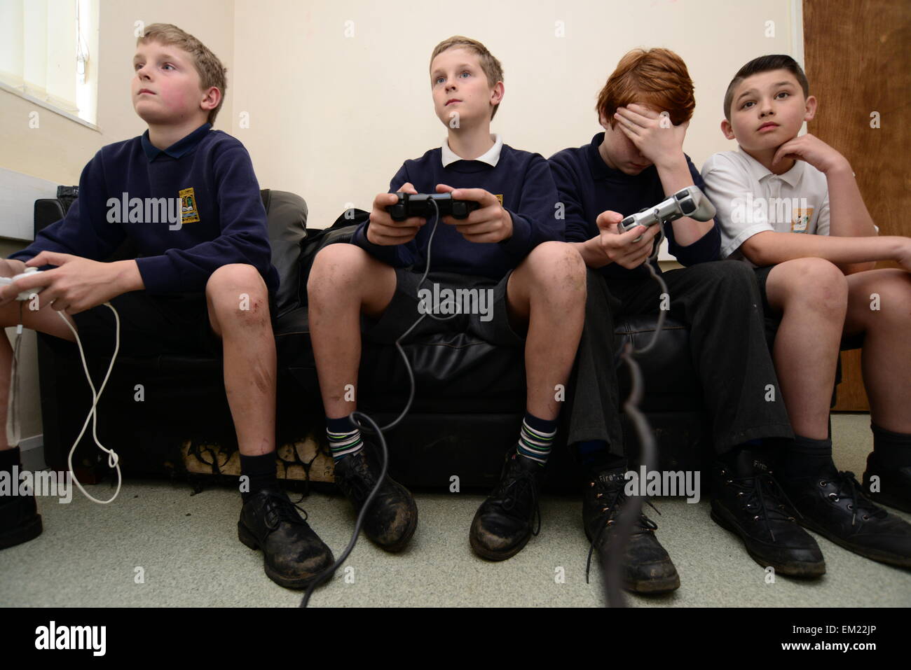 Young boys playing on a Sony Playstation. Picture: Scott Bairstow/Alamy Stock Photo