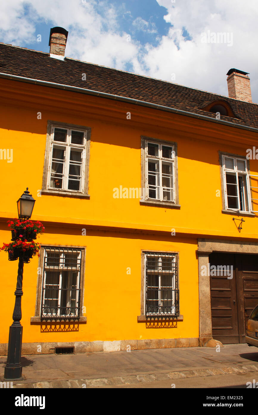 A Painted Yellow Building In The Castle District; Budapest Hungary Stock Photo