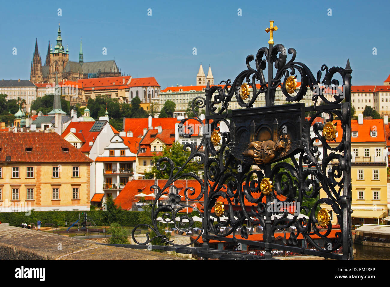 Bronze Relief On Charles Bridge Or Karluv Most With Royal Palace In The Background; Prague Czech Republic Stock Photo