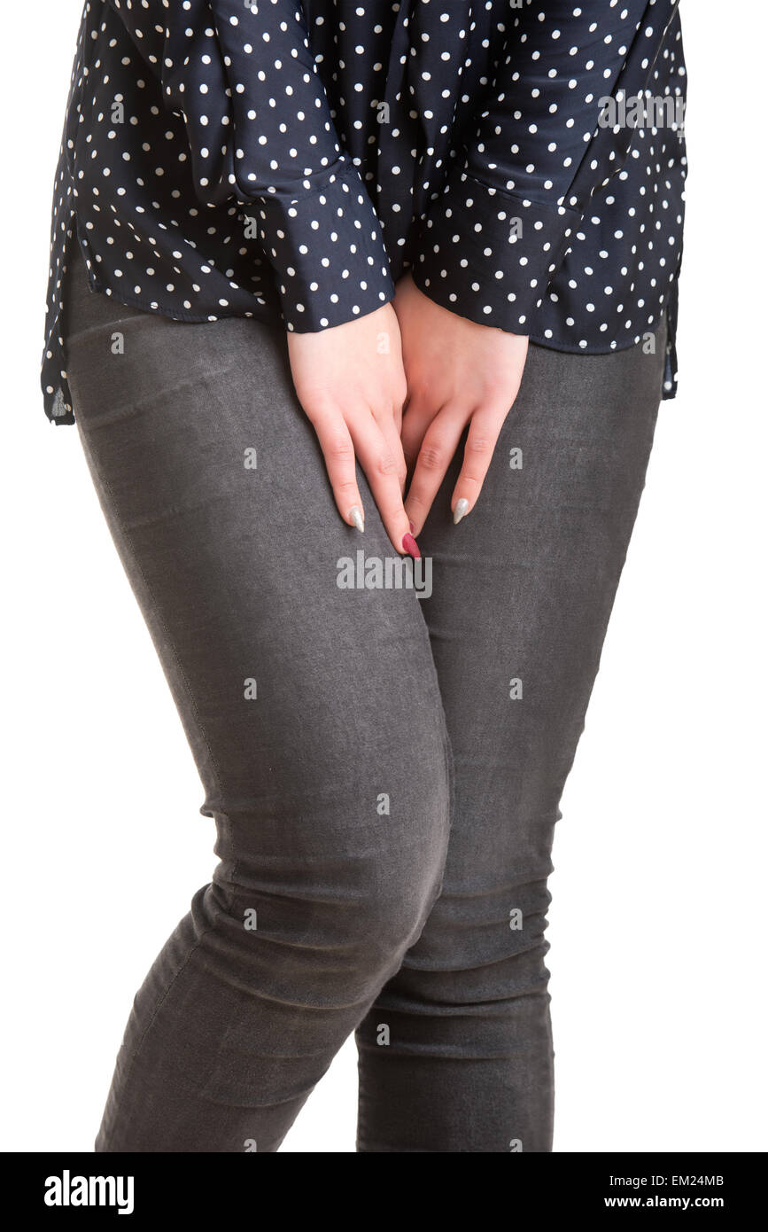 Close up of a woman with hands holding her crotch, isolated in white Stock Photo