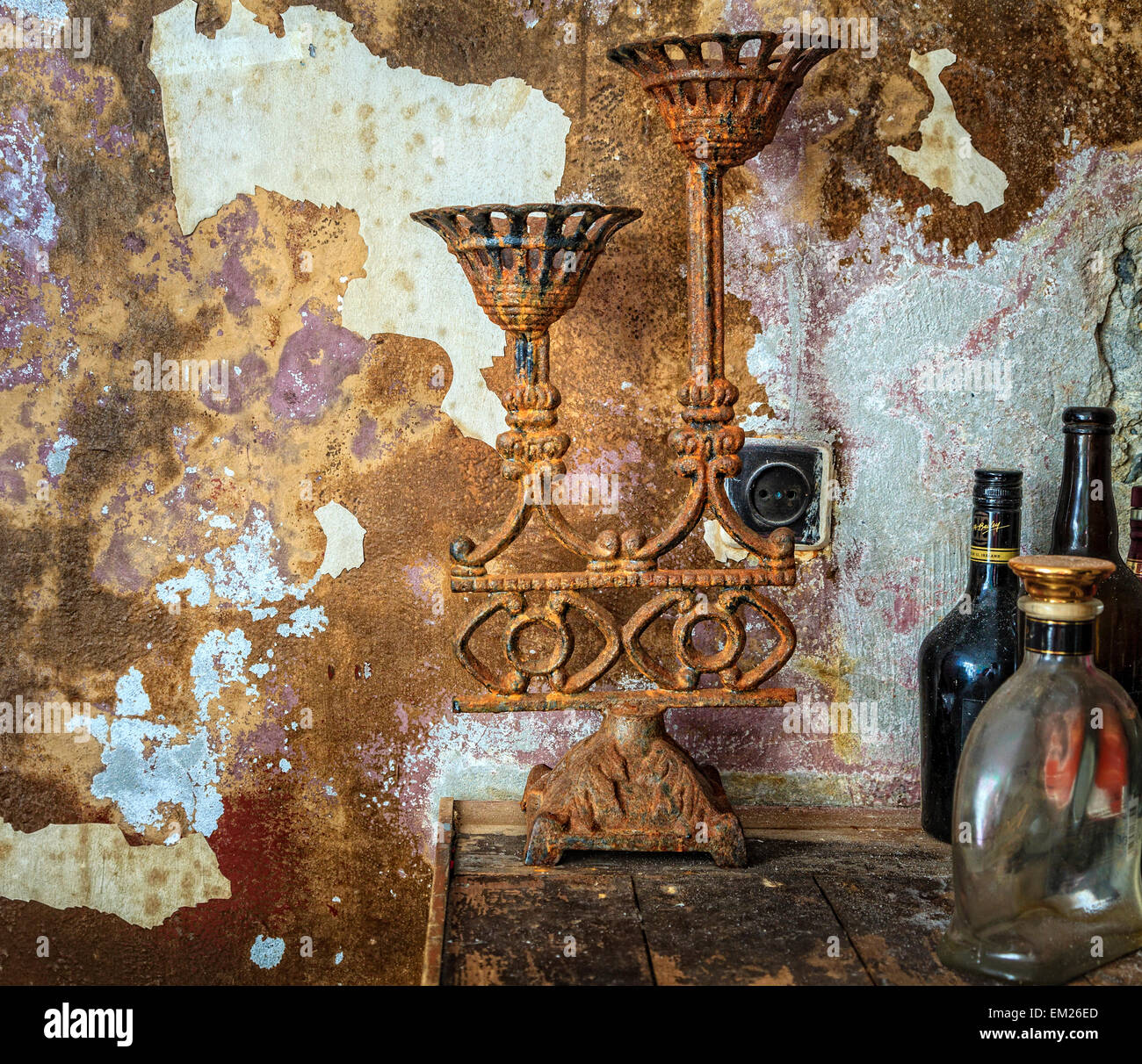 Old rusted candelabra and empty bottles at an abandoned shop in Iceland Stock Photo
