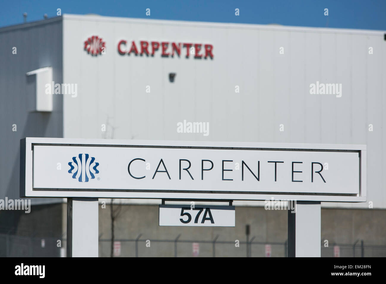 A logo sign outside of a facility operated by the cushioning products manufacturer Carpenter Ltd. Stock Photo