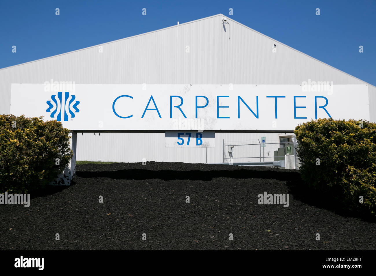 A logo sign outside of a facility operated by the cushioning products manufacturer Carpenter Ltd. Stock Photo
