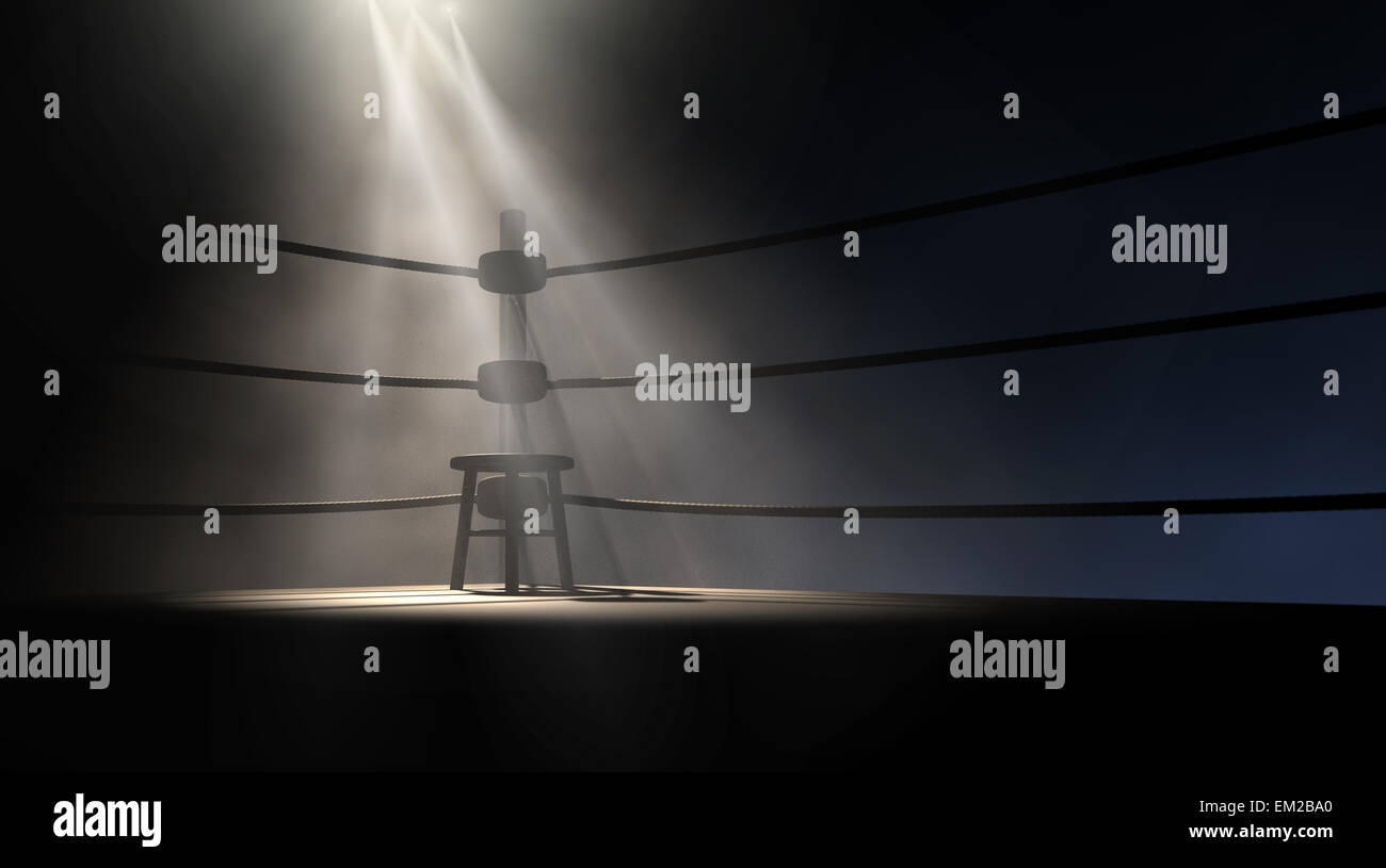 A dramatic view of the corner of an old vintage boxing ring with an empty stool spotlit by a single spotlight on an isolated dar Stock Photo