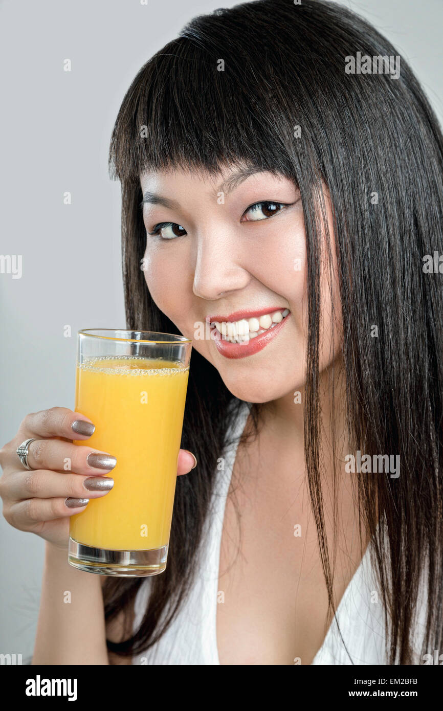 asian woman drinking orange juice Stock Photo Alamy