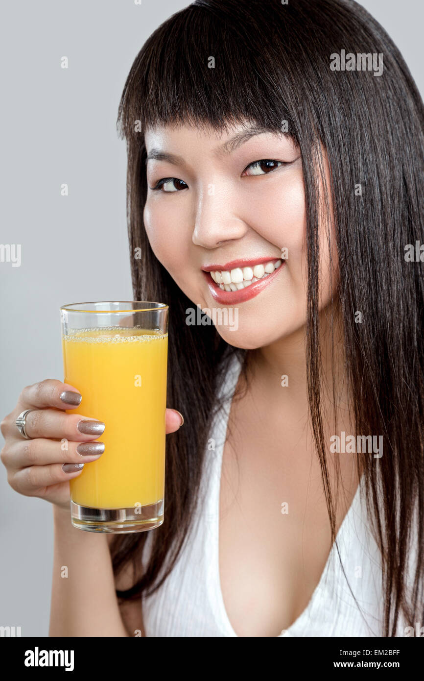 asian woman drinking orange juice Stock Photo Alamy
