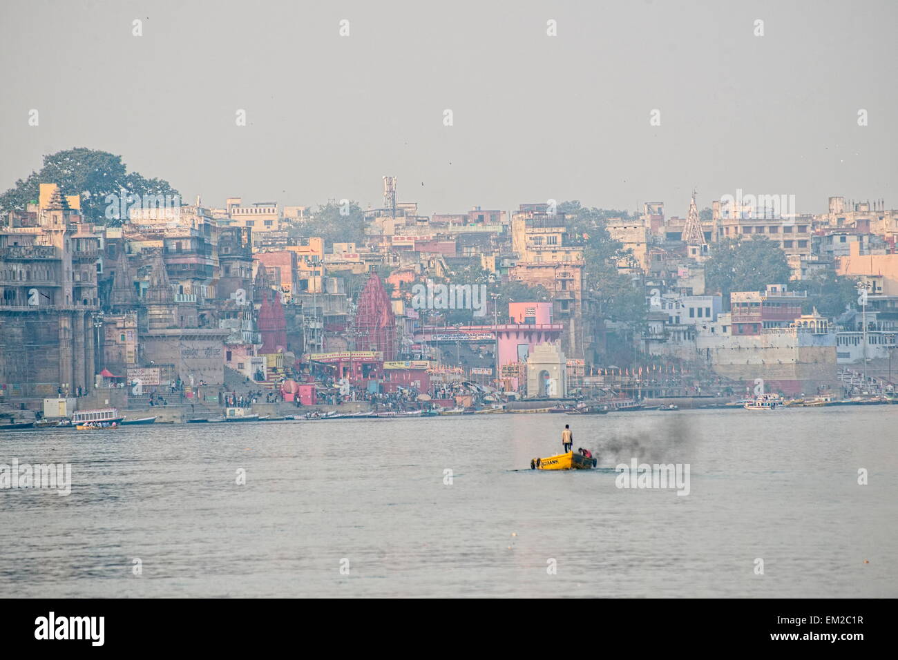 Man standing at the middle of the Ganges, looking at Varanasi's main ghat Stock Photo