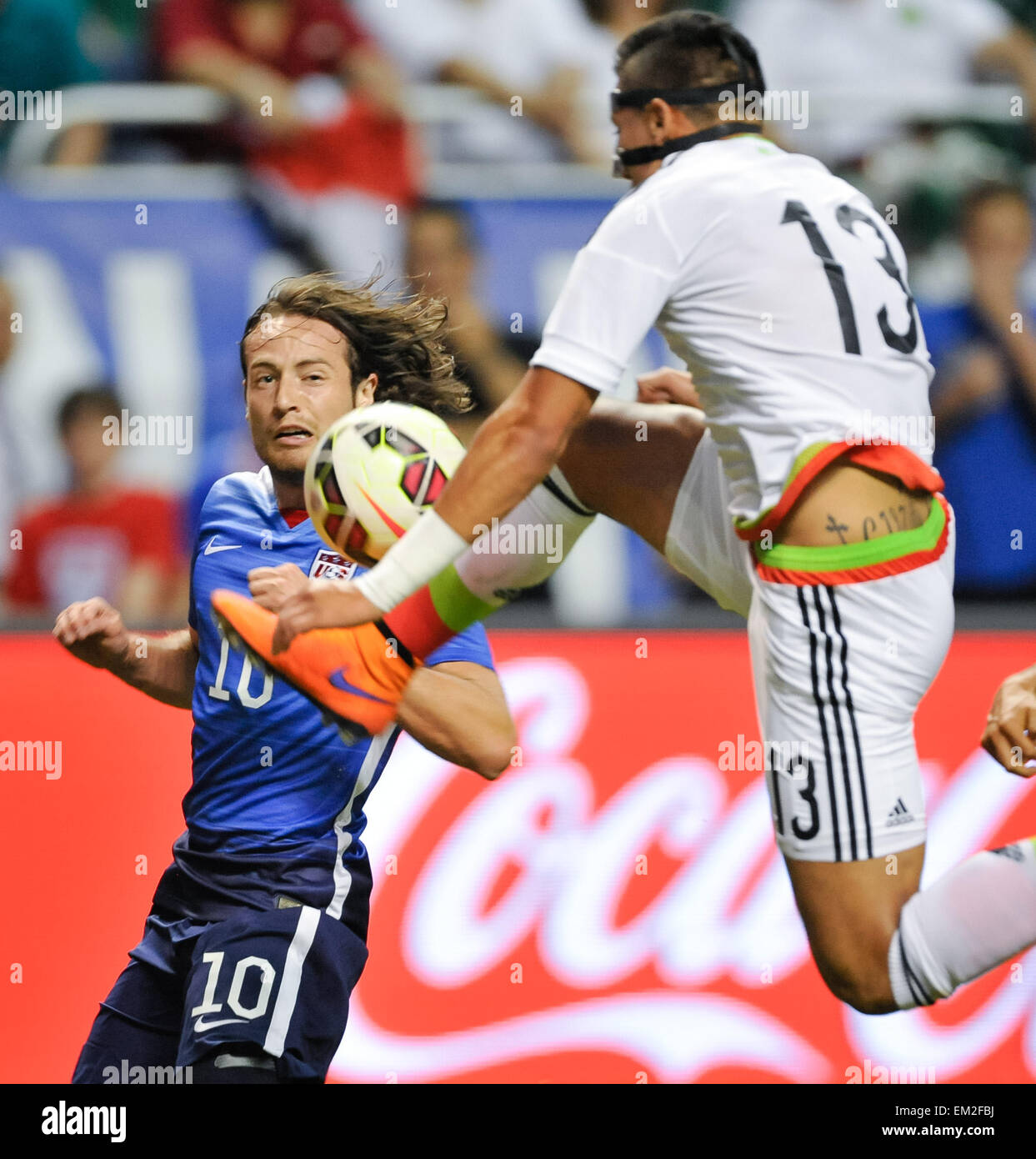 San Antonio, TX, USA. 15th Apr, 2015. Mexico's Carlos Salcedo, 13, goes high to control the ball in front of USA's Mix Diskerud during a friendly match Wednesday April 15, 2015 at the Alamodome in San Antonio, Texas. The US Men's National team defeated Mexico, 2-0. © Bahram Mark Sobhani/ZUMA Wire/Alamy Live News Stock Photo