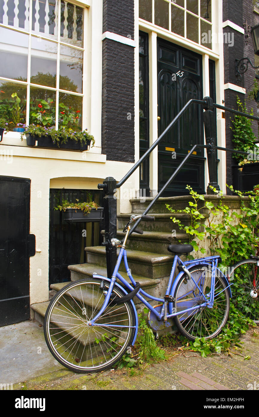Purple Bike Outside A House On Brouwersgracht; Amsterdam Netherlands Stock Photo