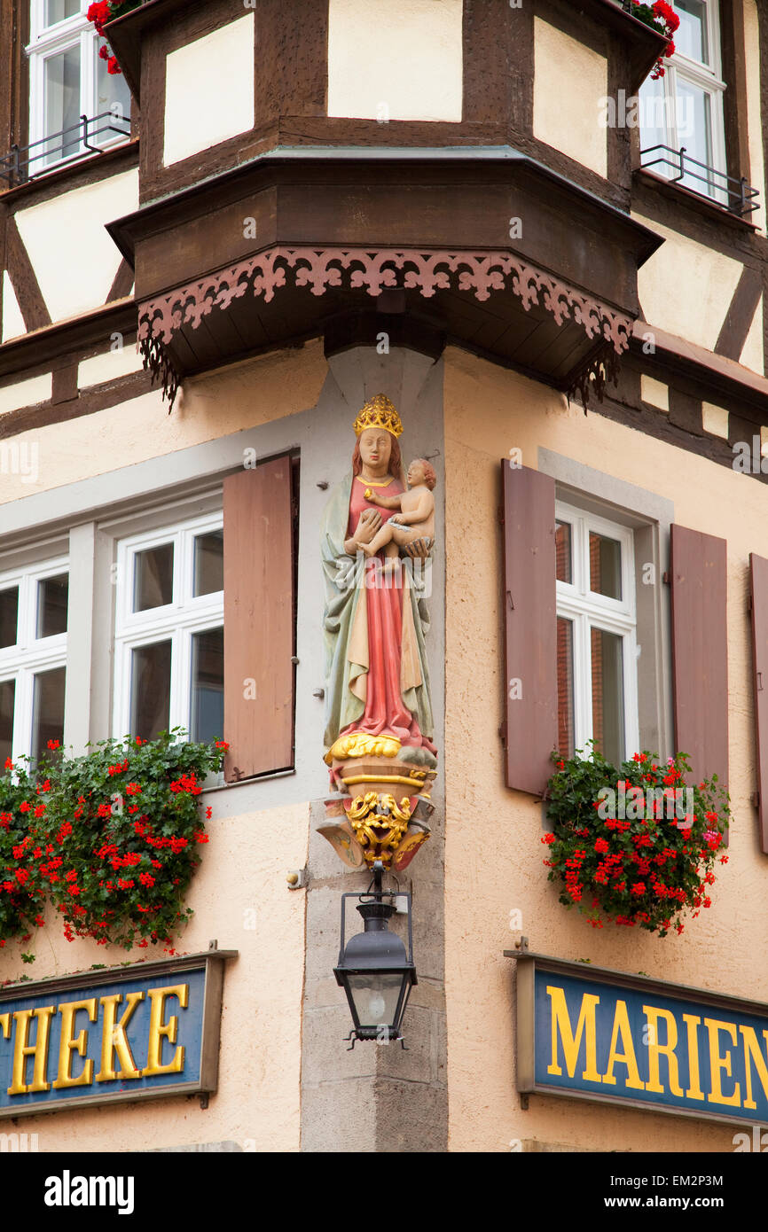Sculpture Of A Female Figure Holding A Baby On The Corner Of A Building; Rothenburg Ob Der Tauber Bavaria Germany Stock Photo