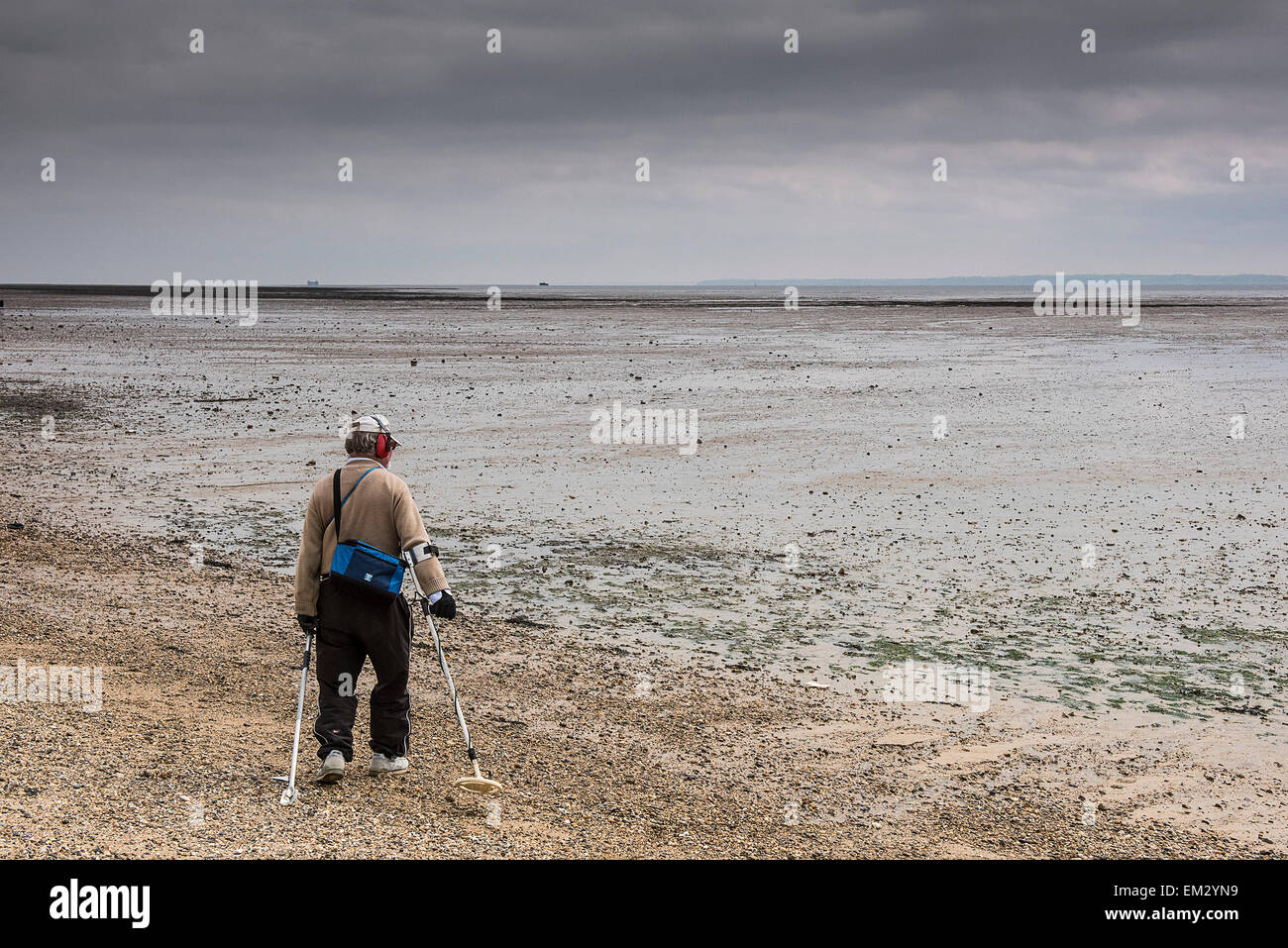 A metal detectorist on City Beach in Southend seafront on a cloudy day