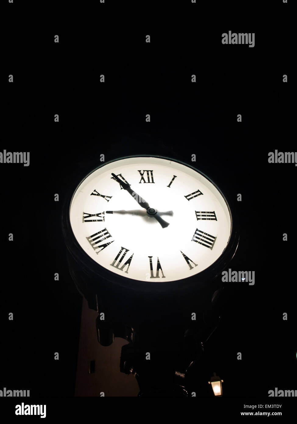 outdoor clock standing at night at 9 pm Stock Photo Alamy