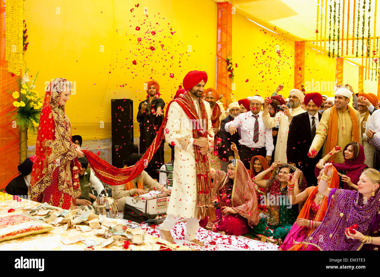 Confetti Being Thrown On A Bride And Groom; Ludhiana, Punjab, India Stock Photo