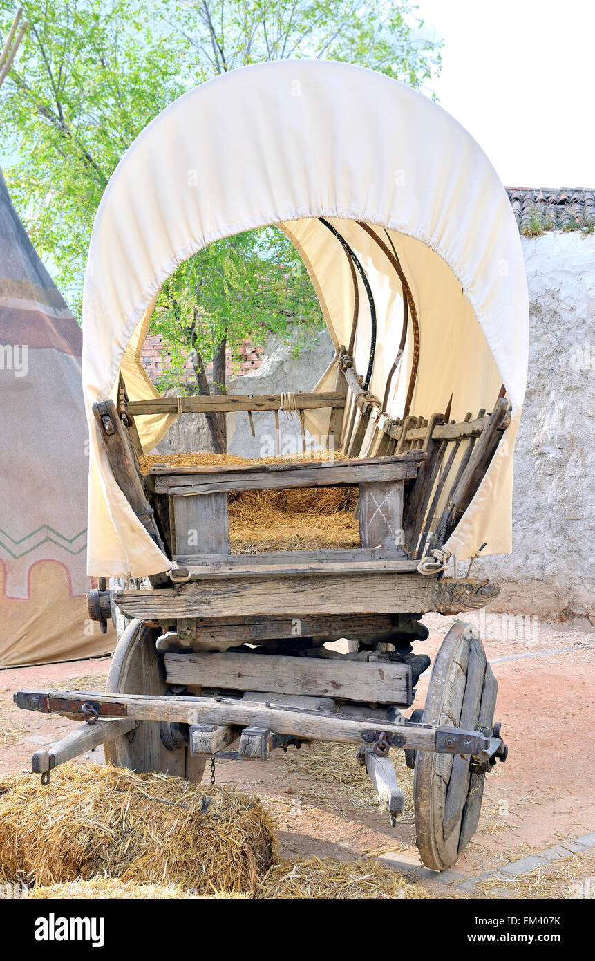 Vintage covered wagon used to transport straw, people and others things