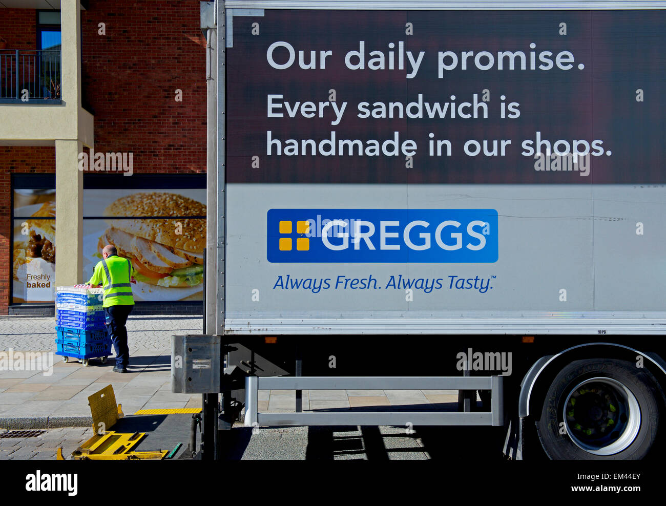 Man unloading produce from Greggs delivery van, England UK Stock Photo