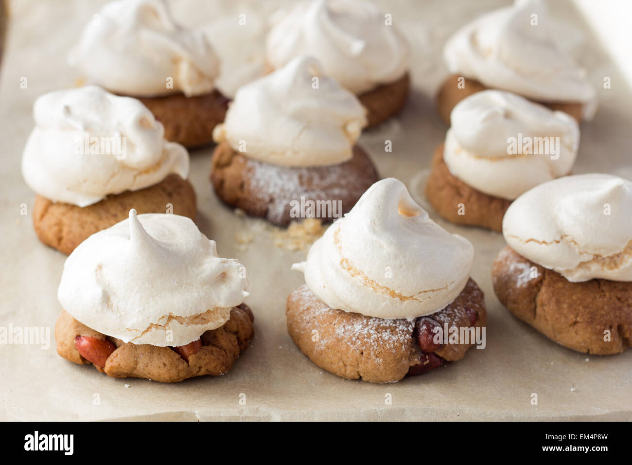 Shot of shortbread cookies with peanut and meringues on cooking paper Stock Photo