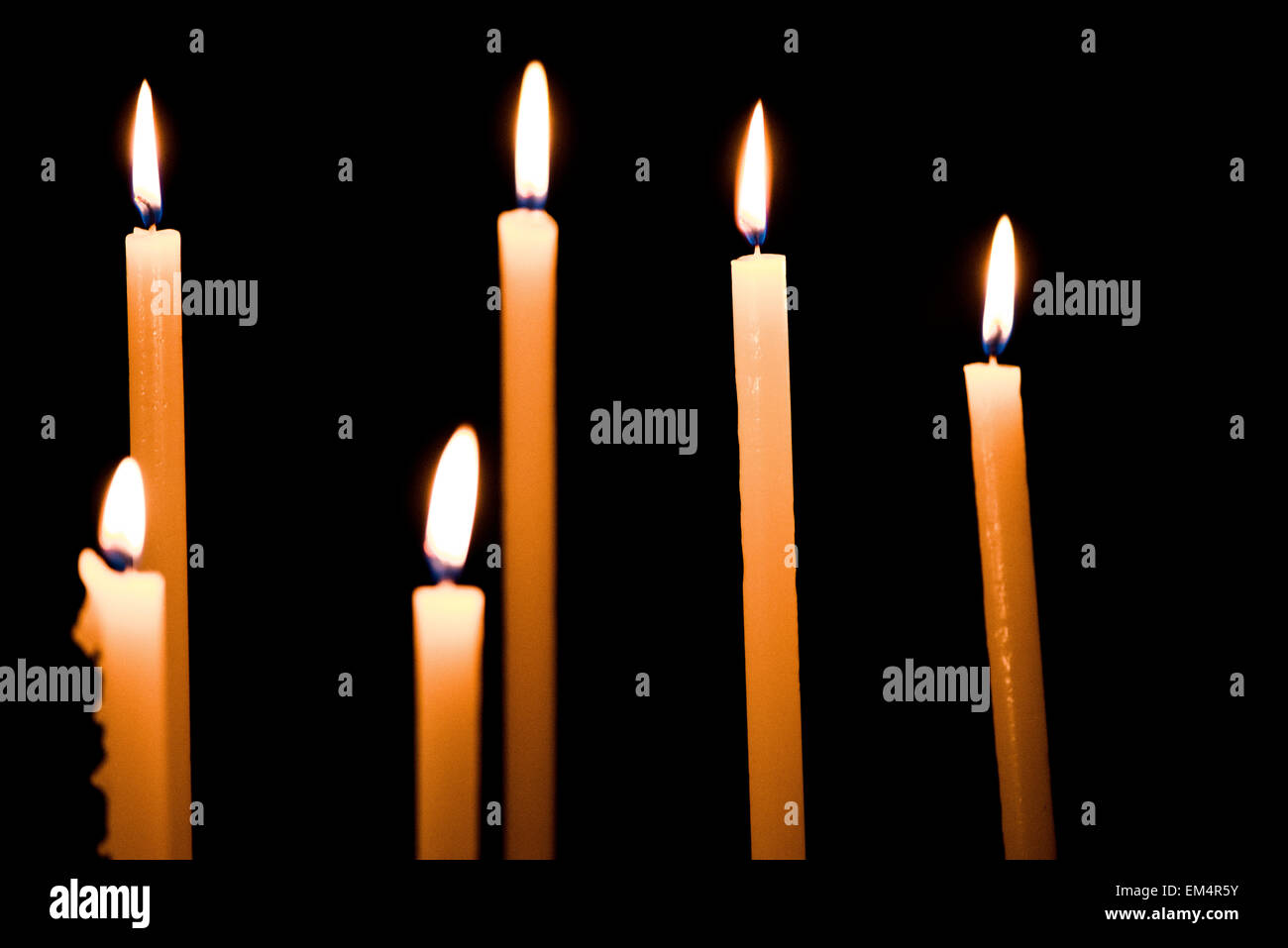 Lighting candles in a church Stock Photo Alamy