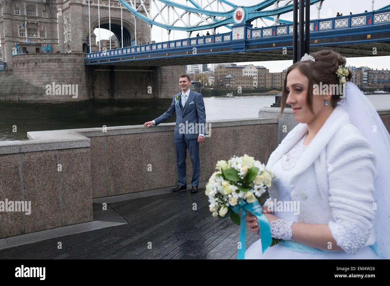 Russian bride and groom having their wedding photos taken at Tower Bridge, London, UK. It is a common site to see Russian and other nationalities having pre-wedding photographs taken at famous sites around the capital. Stock Photo