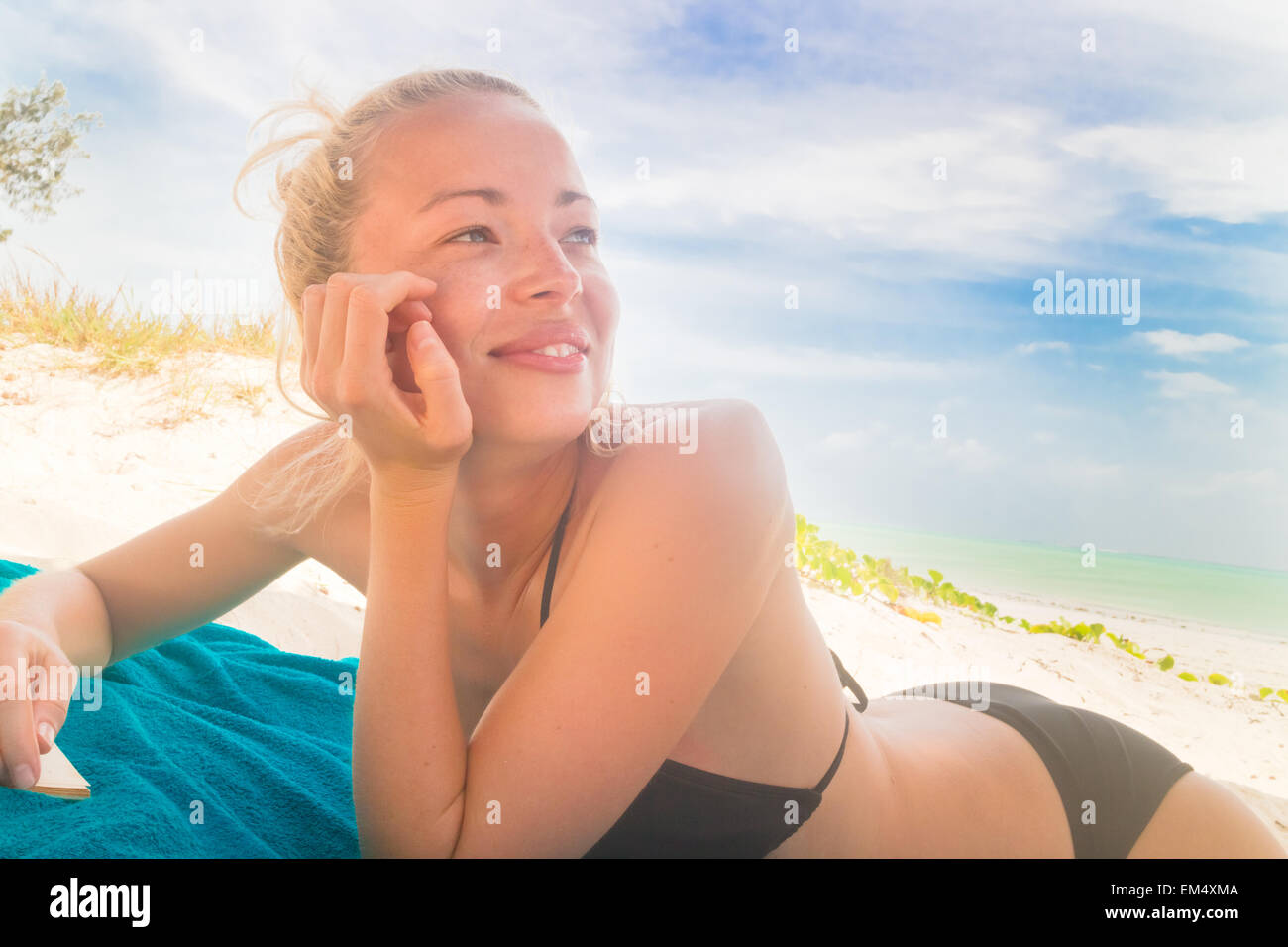 Happy woman in bikini on the beach. Stock Photo