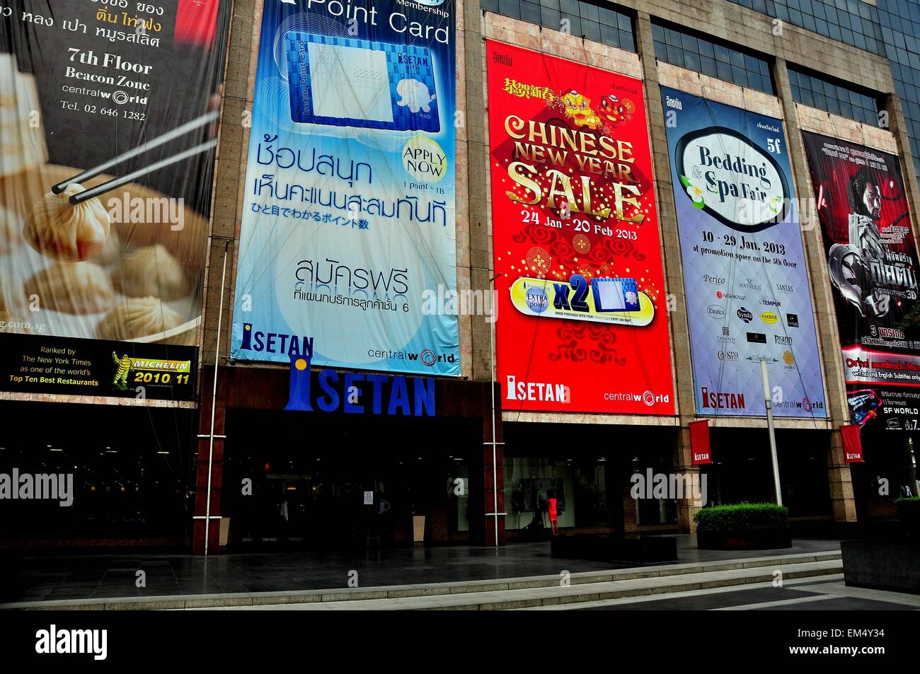 Bangkok, Thailand:  Advertising billboards promoting sales, restaurants, and films cover the entrance facade at Istetan store Stock Photo
