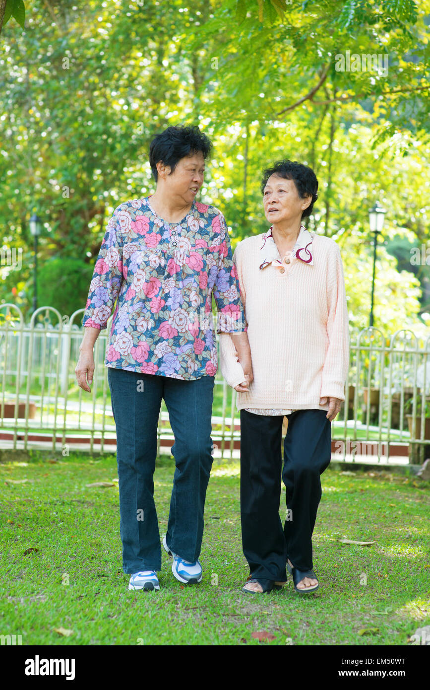 Asian senior women walking at outdoor park. Stock Photo