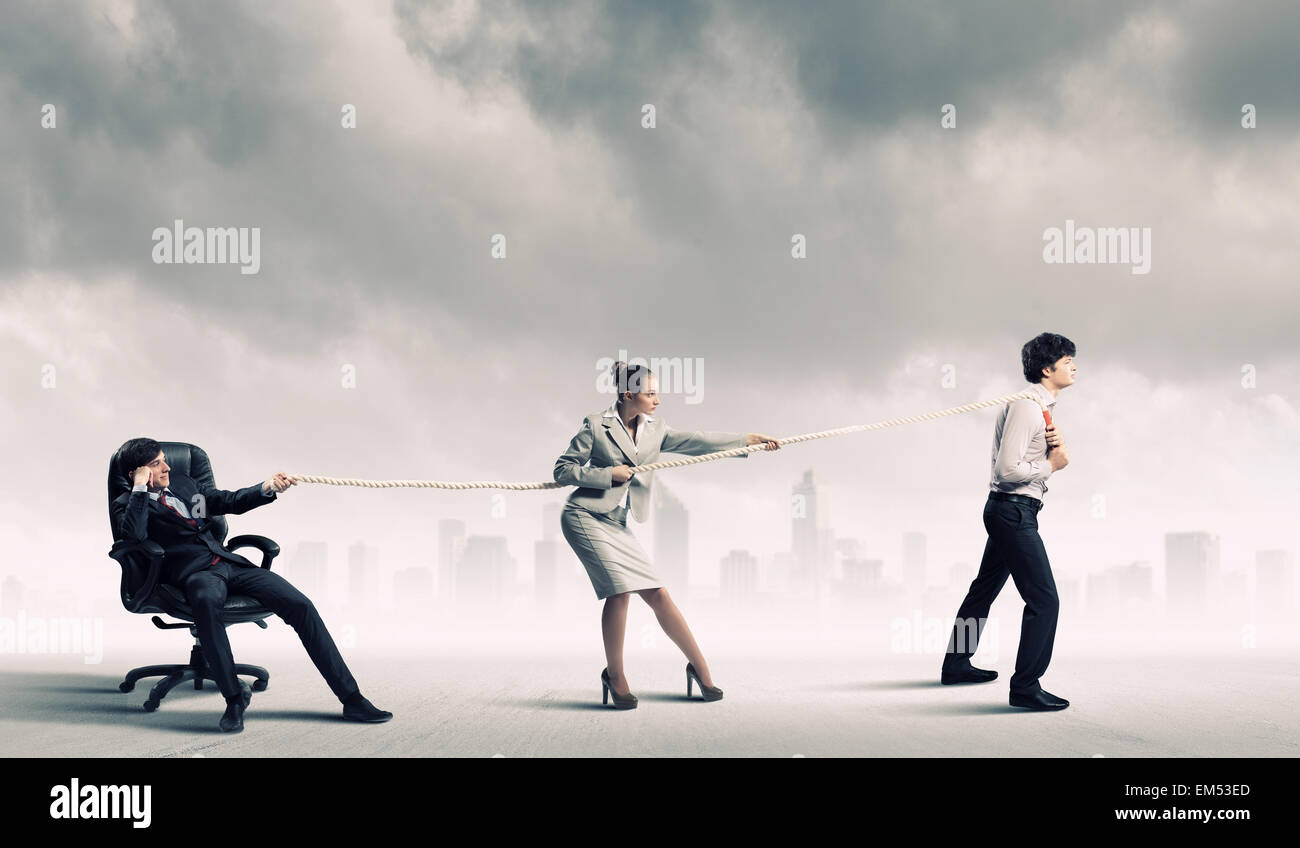 Three business people pulling rope Stock Photo - Alamy