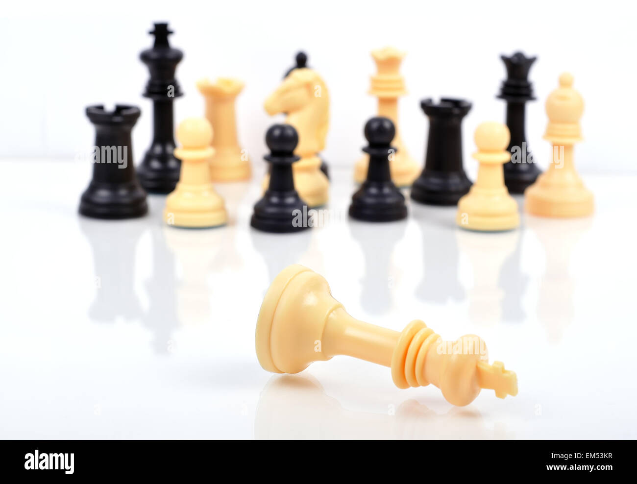 checkmate black defeats white king on white background Stock Photo - Alamy