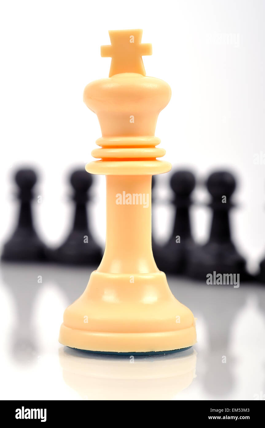 white chess king and black pieces, close up Stock Photo