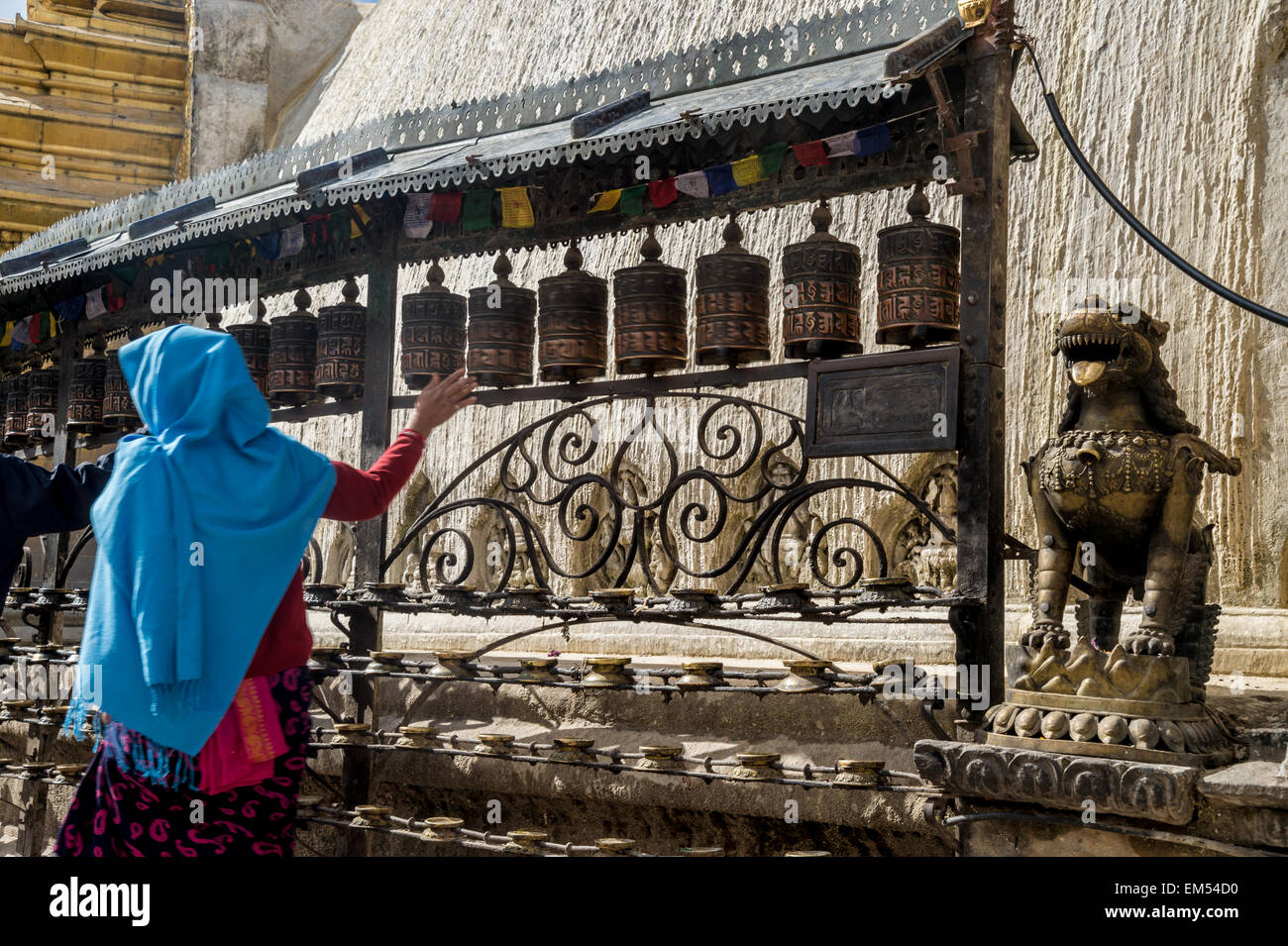 Monkey Temple, Kathmandu, Nepal. Nepali woman turning prayer wheels. Nepali woman turning prayer wheels Stock Photo