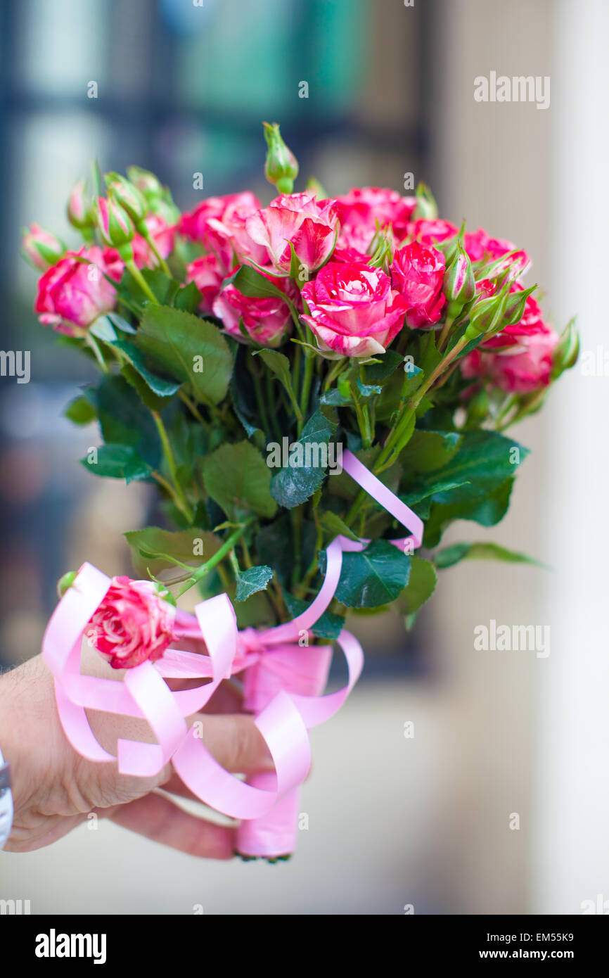 Charming bouquet of roses in woman's hand Stock Photo