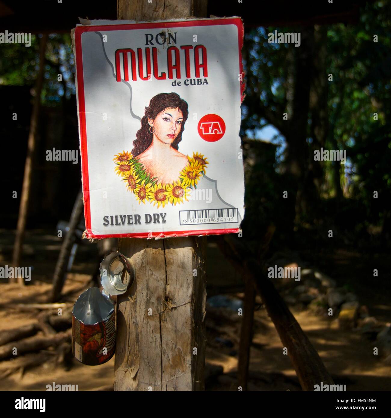 Rum box nailed to a tree with a pot to collect tips in Cuba Stock Photo
